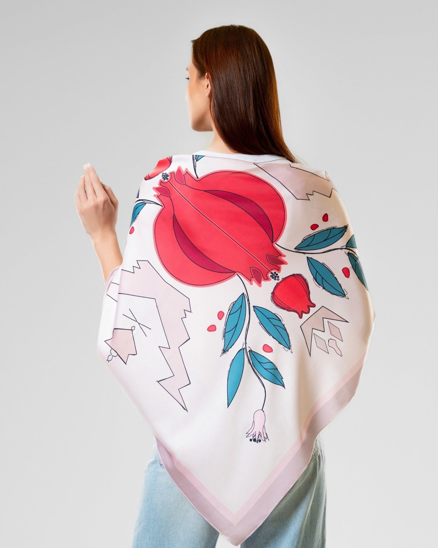 Woman wearing a floral kimono-style silk garment with a white background