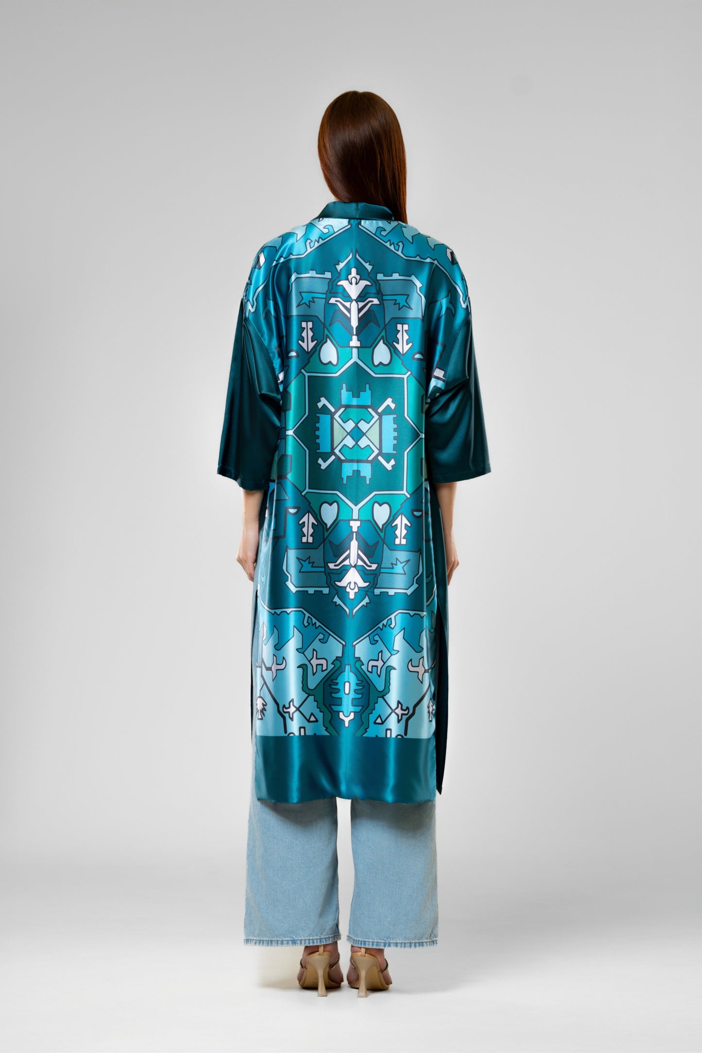 Person wearing a colorful patterned silk robe with signature design