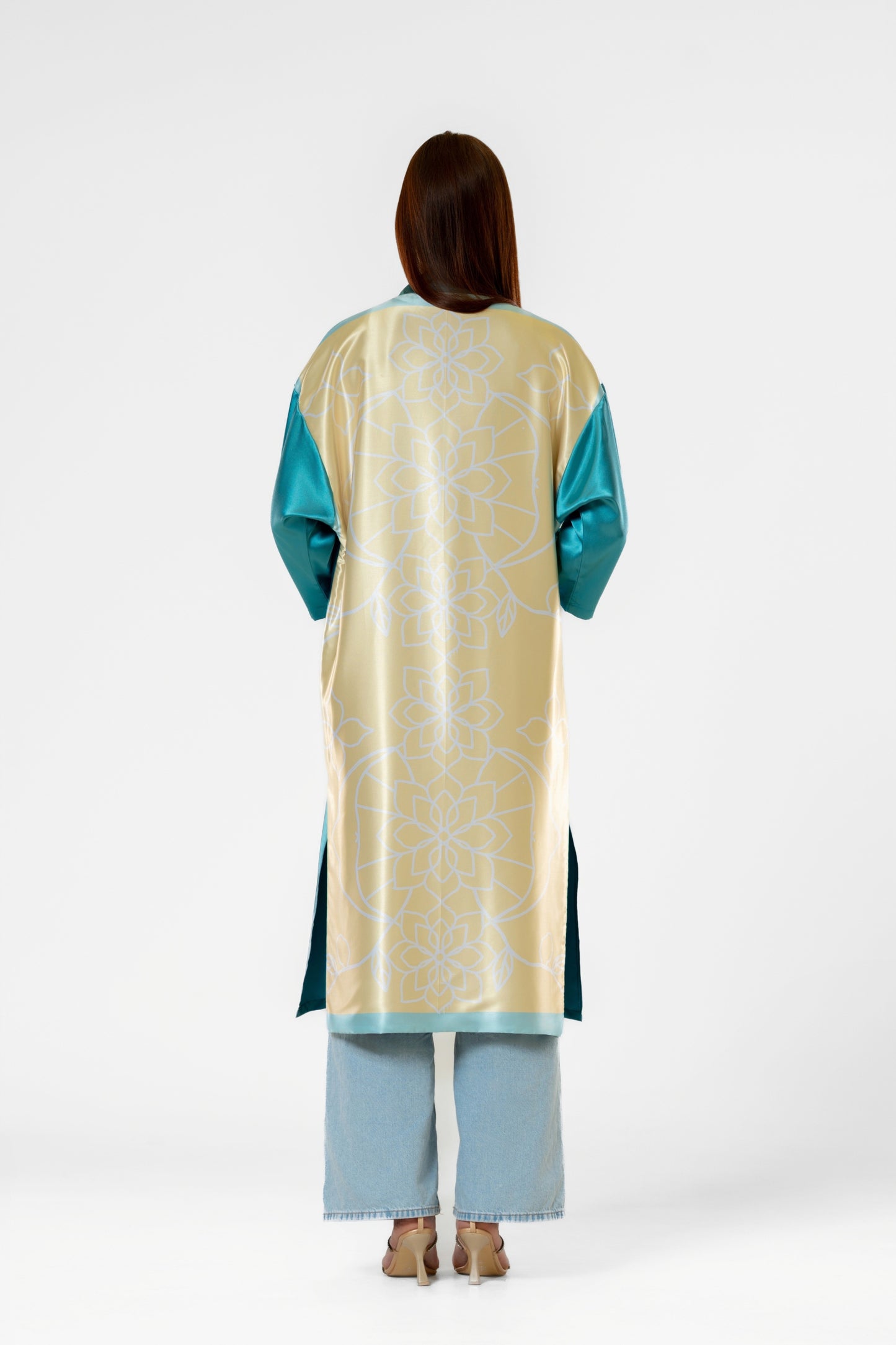 Person wearing a colorful patterned silk robe with signature design