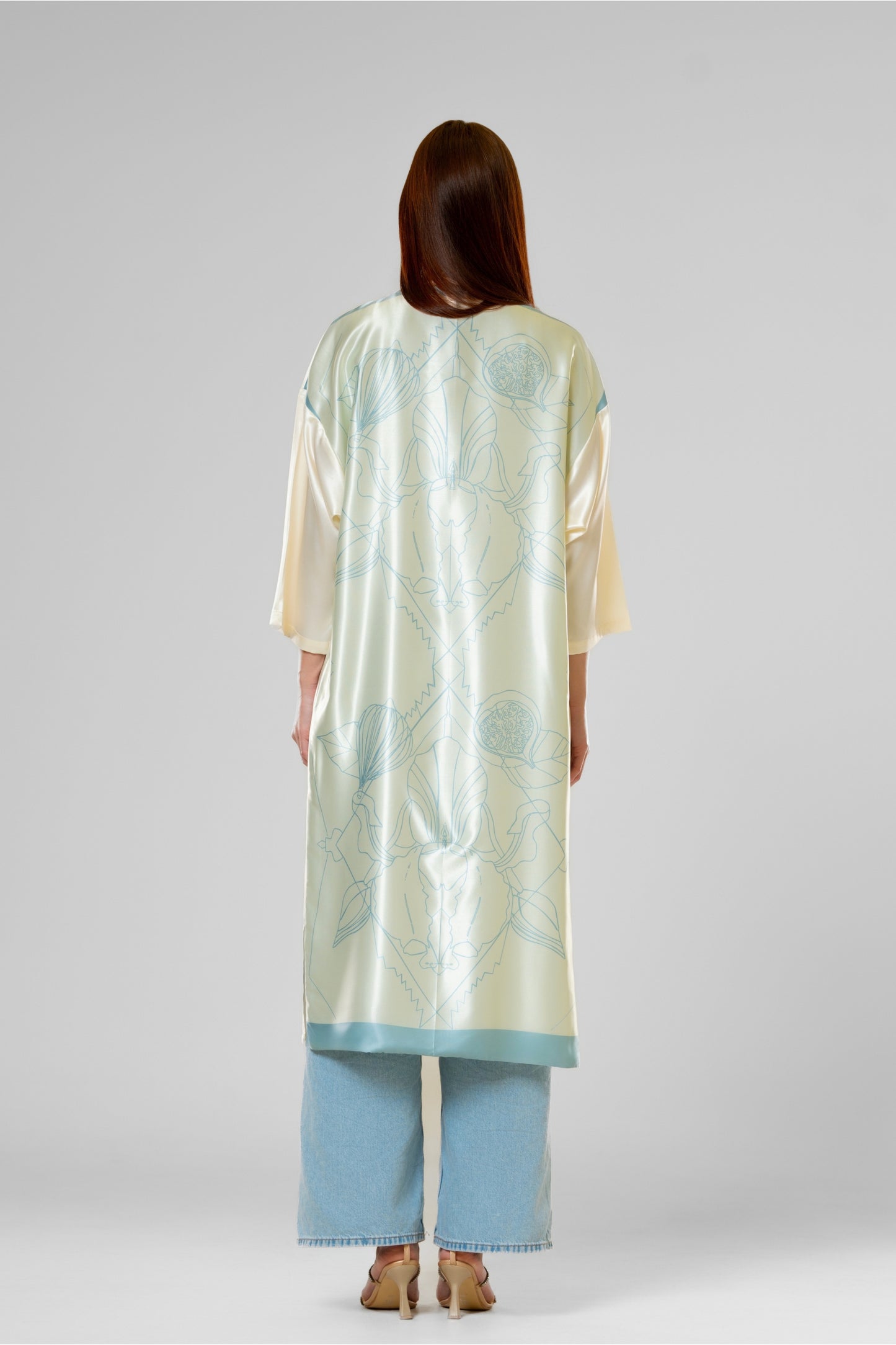 Person wearing a colorful patterned silk robe with signature design