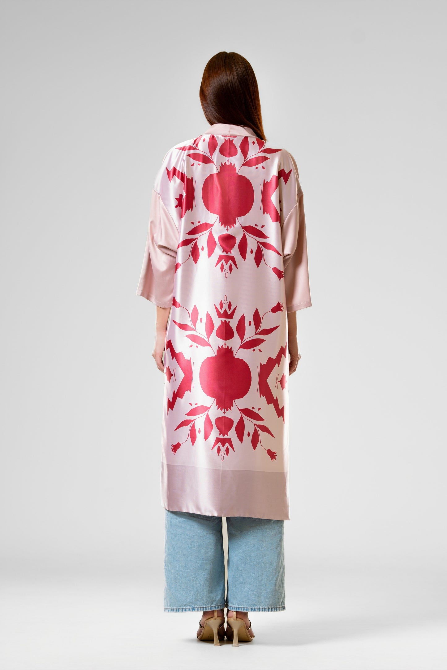Person wearing a colorful patterned silk robe with signature design