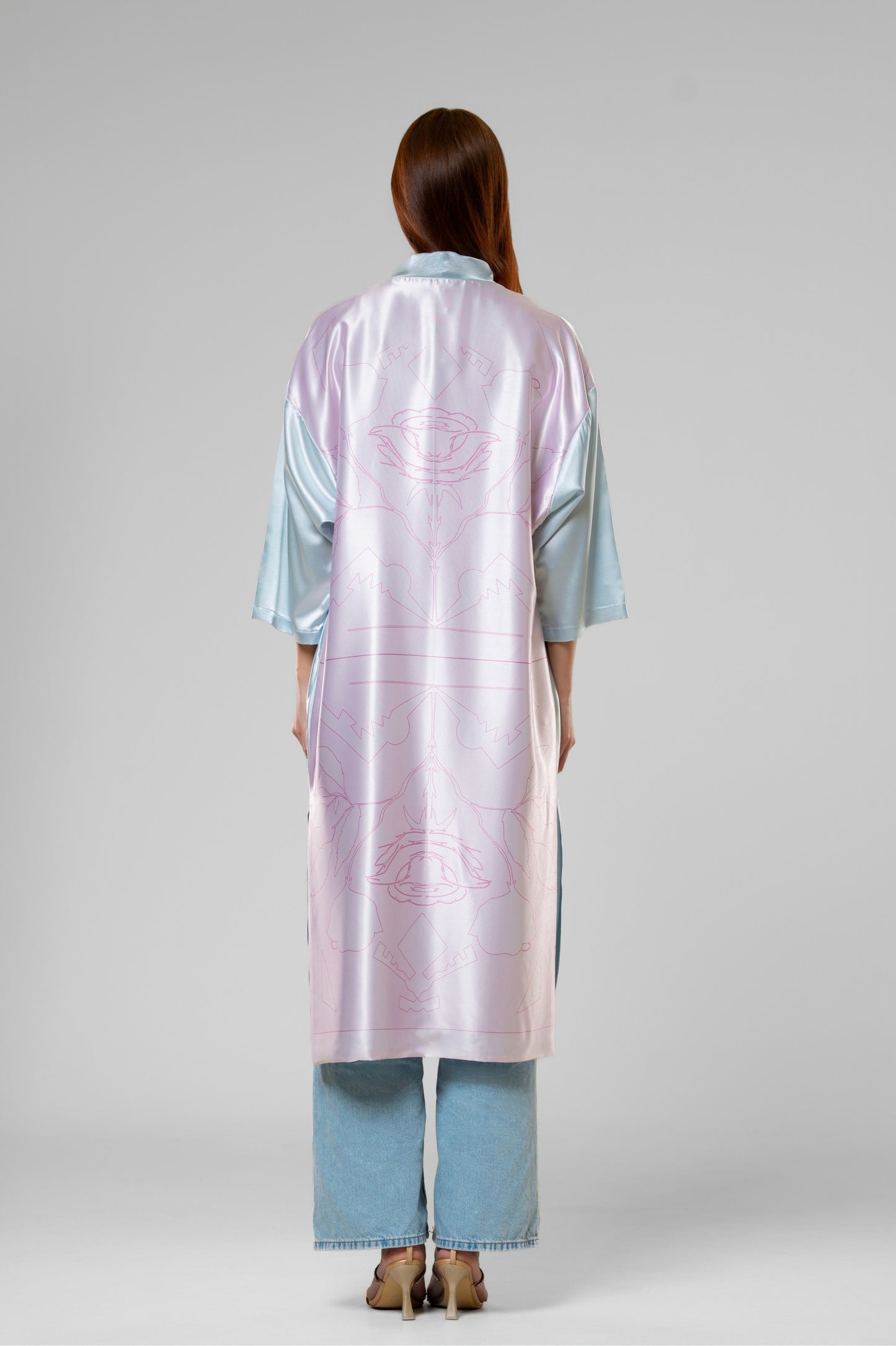 Person wearing a colorful patterned silk robe with signature design