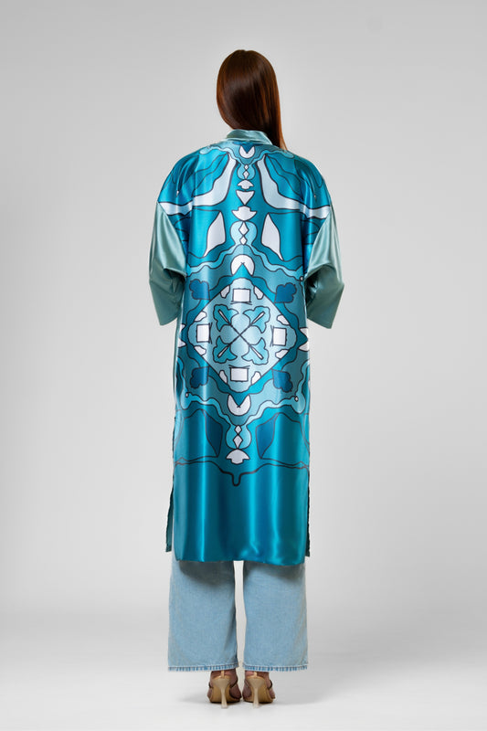 Person wearing a colorful patterned silk robe with signature design
