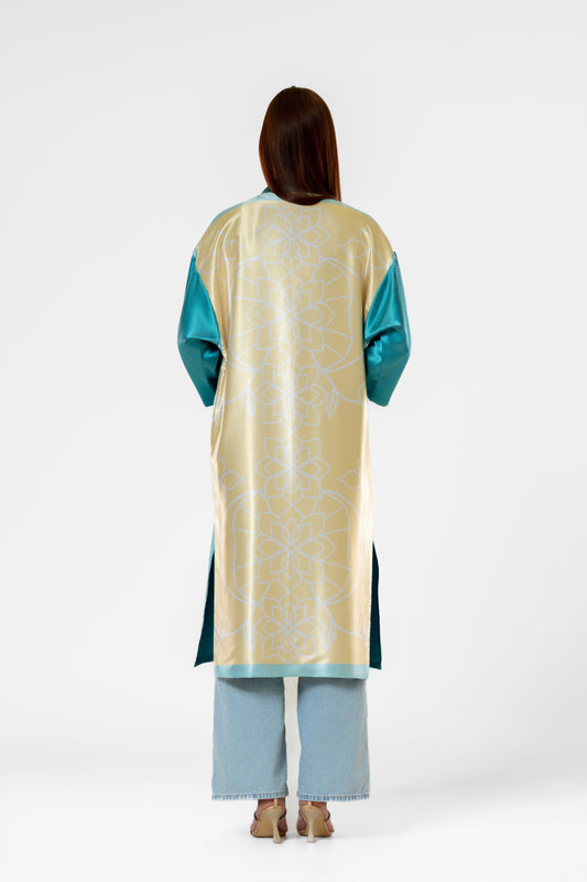 Person wearing a colorful patterned silk robe with signature design