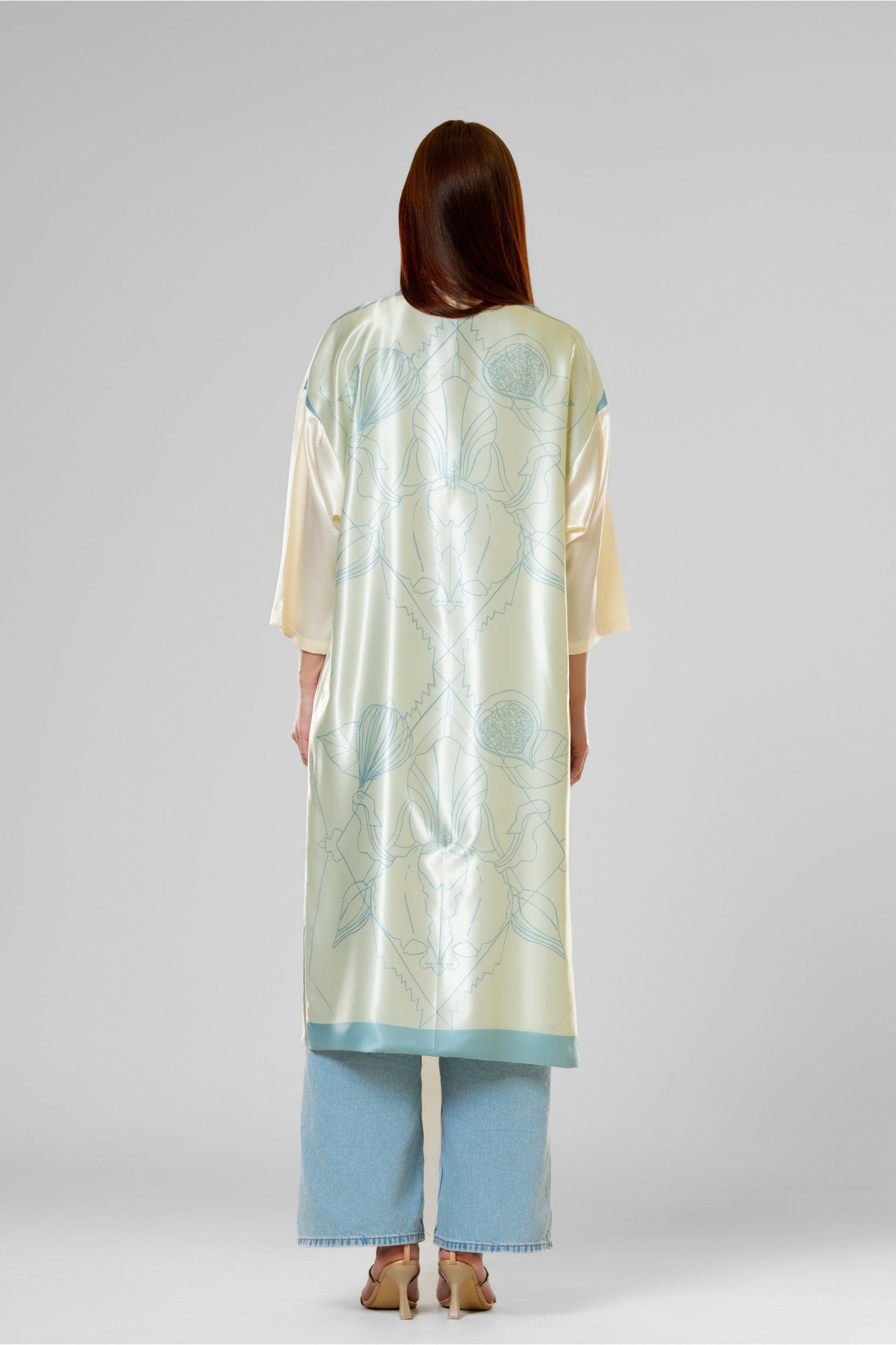 Person wearing a colorful patterned silk robe with signature design