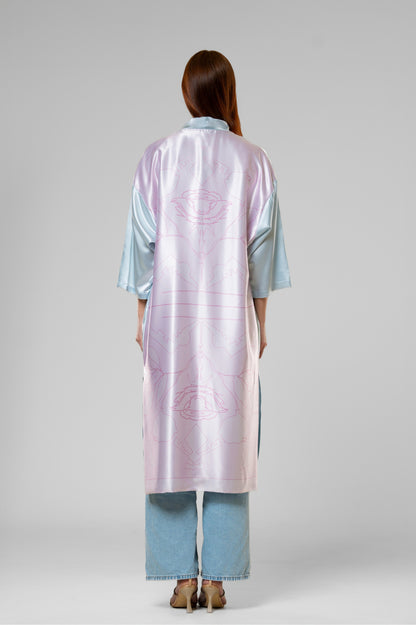 Person wearing a colorful patterned silk robe with signature design