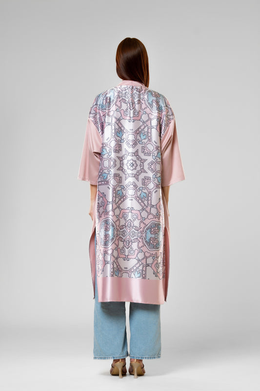 Person wearing a colorful patterned silk robe with signature design