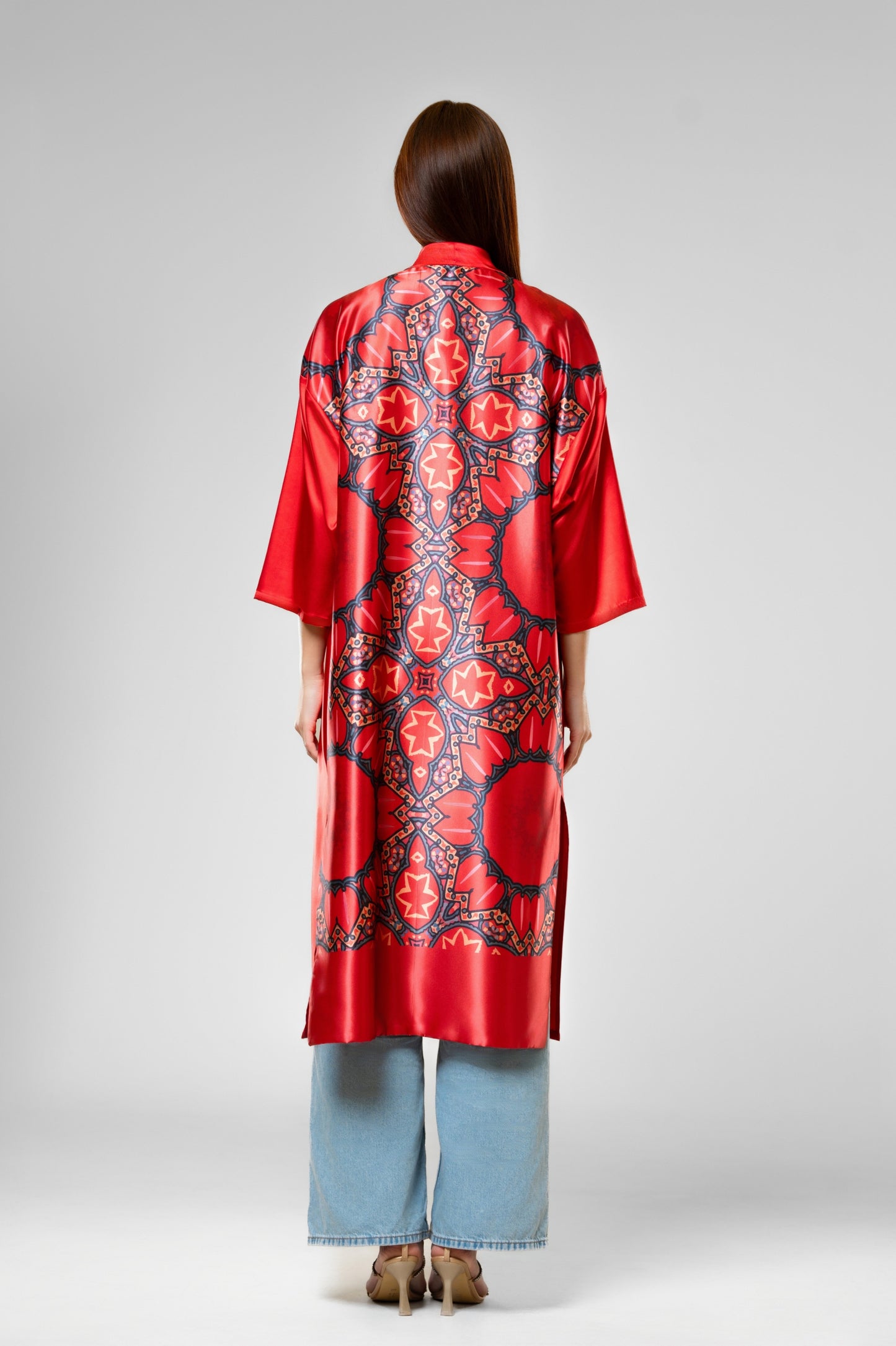 Person wearing a colorful patterned silk robe with signature design