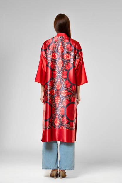Person wearing a colorful patterned silk robe with signature design