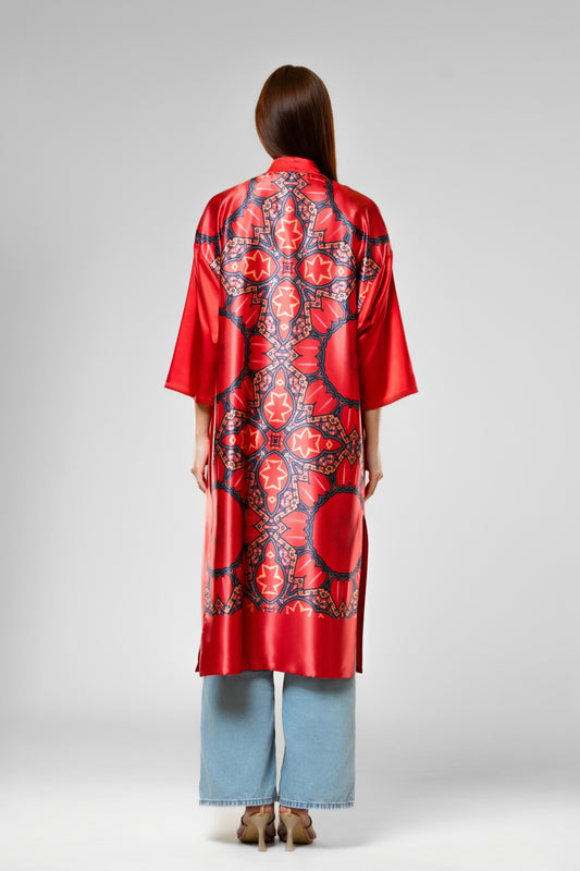Person wearing a colorful patterned silk robe with signature design